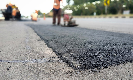 AAA Asphalt workers repairing asphalt